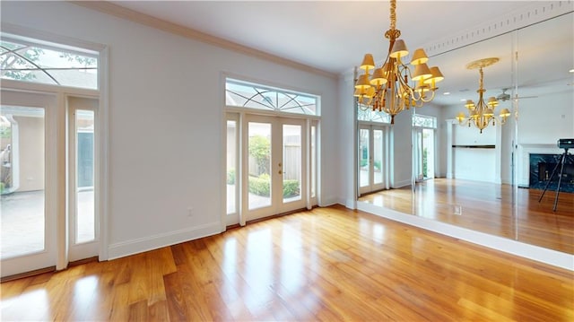 3739 N Hullen St, Metairie, LA 70002 - unfurnished dining area featuring a chandelier, plenty of natural light, wood finished floors, and crown molding