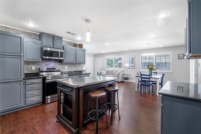 1200 Waltham St, Metairie, LA 70001 - kitchen featuring stainless steel appliances, plenty of natural light, tasteful backsplash, dark wood finished floors, and recessed lighting