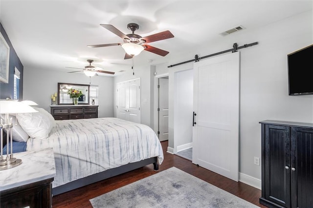 1200 Waltham St, Metairie, LA 70001 - bedroom with a barn door, wood finished floors, and ceiling fan