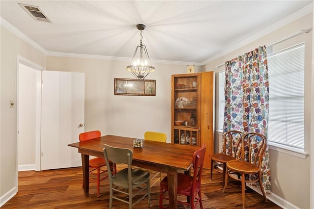 1404 Colony Pl, Metairie, LA 70003 - dining space featuring wood finished floors, a chandelier, and crown molding