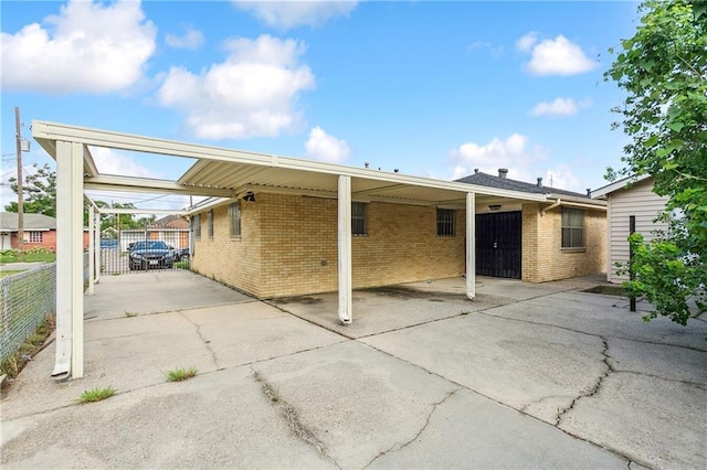 4925 Rhodes Dr, New Orleans, LA 70126 - back of property with brick siding and a carport
