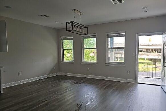 2678 Myrtle St, New Orleans, LA 70122 - unfurnished dining area featuring dark wood-style floors and a chandelier