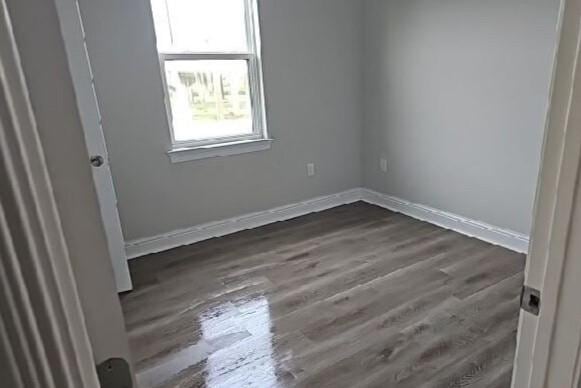 2678 Myrtle St, New Orleans, LA 70122 - empty room with dark wood finished floors and baseboards