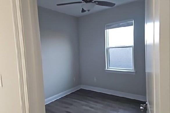 2678 Myrtle St, New Orleans, LA 70122 - empty room featuring ceiling fan and dark wood-style flooring