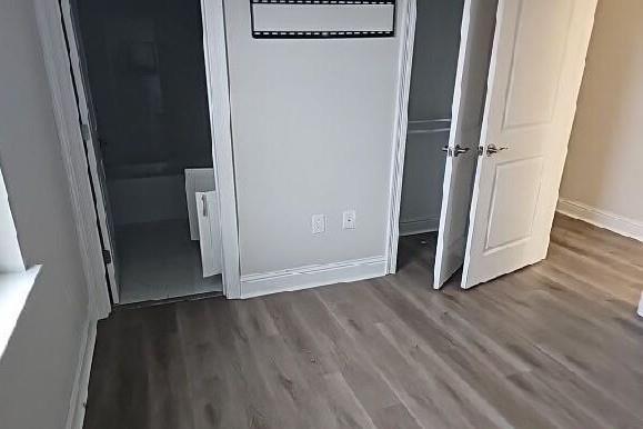2678 Myrtle St, New Orleans, LA 70122 - unfurnished bedroom with wood finished floors and a closet