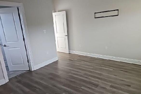 2678 Myrtle St, New Orleans, LA 70122 - spare room featuring dark wood-style floors and baseboards
