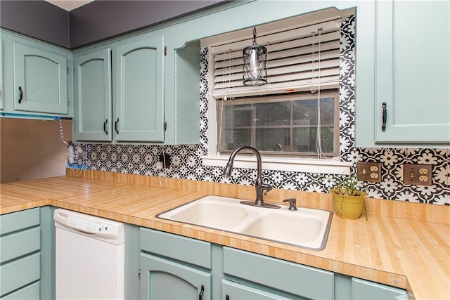 2129 Hamilton St, Franklinton, LA 70438 - kitchen featuring white dishwasher, light countertops, and tasteful backsplash