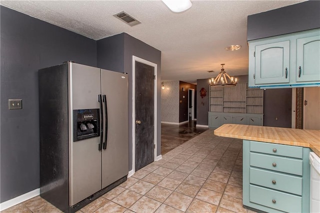 2129 Hamilton St, Franklinton, LA 70438 - kitchen featuring stainless steel refrigerator with ice dispenser, a chandelier, light countertops, a textured ceiling, and dishwasher
