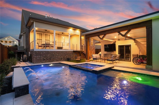 6938 Milne Blvd, New Orleans, LA 70124 - back of house with ceiling fan, a pool with connected hot tub, stairway, and a patio area