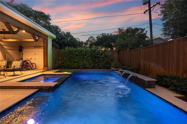 6938 Milne Blvd, New Orleans, LA 70124 - pool at dusk with a fenced backyard, a patio, and a pool with connected hot tub