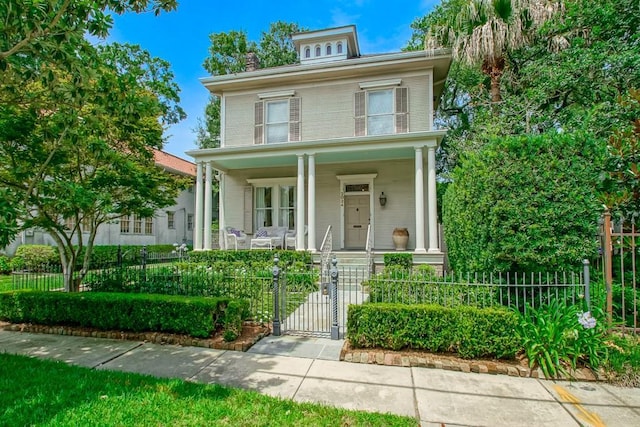 2024 General Pershing St, New Orleans, LA 70115 - traditional style home featuring covered porch, a gate, and a fenced front yard