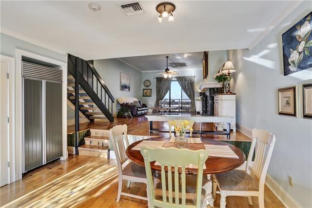 7300 Lakeshore Dr Unit 6, New Orleans, LA 70124 - dining space featuring wood finished floors, stairs, crown molding, and ceiling fan