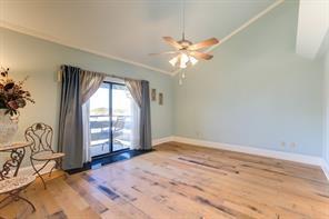 7300 Lakeshore Dr Unit 6, New Orleans, LA 70124 - empty room with wood finished floors, crown molding, ceiling fan, and lofted ceiling