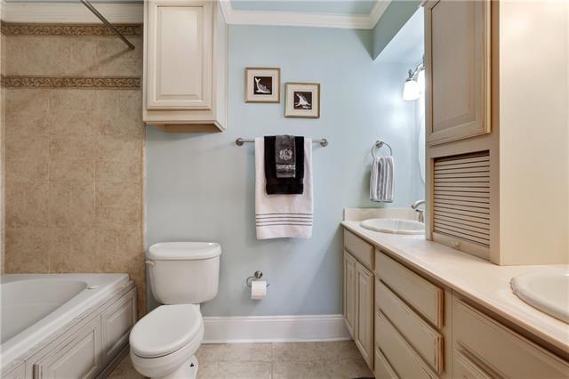 7300 Lakeshore Dr Unit 6, New Orleans, LA 70124 - full bathroom with double vanity, tile patterned floors, ornamental molding, and  shower combination