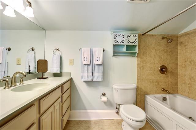 7300 Lakeshore Dr Unit 6, New Orleans, LA 70124 - bathroom featuring vanity, bathing tub / shower combination, and tile patterned floors