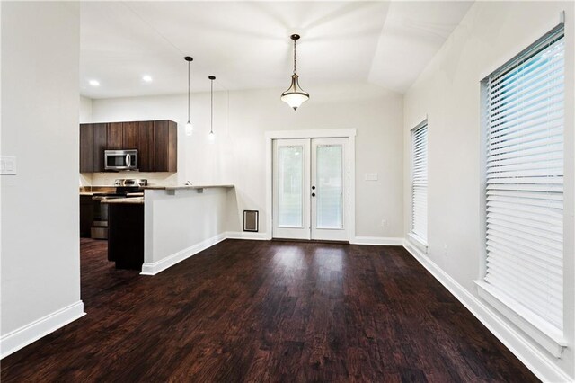 22562 2nd St, Mandeville, LA 70471 - kitchen with appliances with stainless steel finishes, french doors, decorative light fixtures, dark brown cabinets, and light countertops