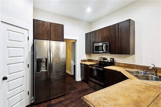 22562 2nd St, Mandeville, LA 70471 - kitchen featuring appliances with stainless steel finishes, dark brown cabinetry, dark wood-style floors, and light countertops