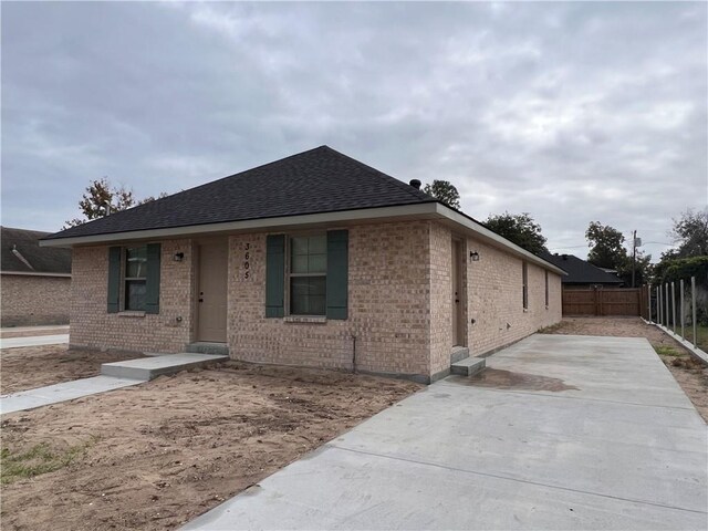 360507 Park Blvd, Chalmette, LA 70043 - ranch-style house featuring brick siding, roof with shingles, and a patio area