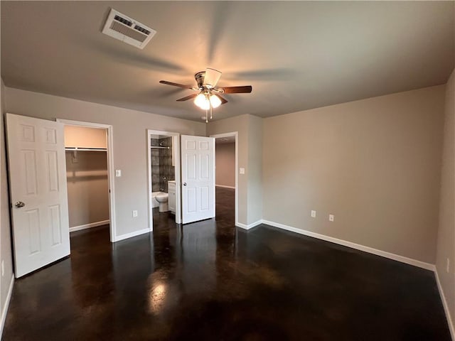 360507 Park Blvd, Chalmette, LA 70043 - unfurnished bedroom with a walk in closet, a closet, ensuite bathroom, finished concrete floors, and ceiling fan