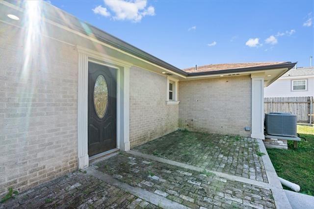 7109 Dreux Ave, New Orleans, LA 70126 - doorway to property featuring brick siding and a patio