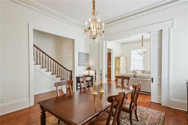 1128 Fourth St, New Orleans, LA 70130 - dining room with a chandelier, crown molding, wood-type flooring, and stairs