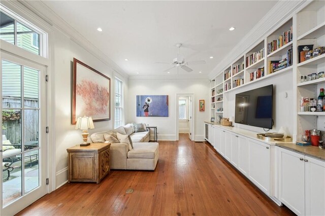 1128 Fourth St, New Orleans, LA 70130 - living room with a ceiling fan, wood-type flooring, recessed lighting, ornamental molding, and built in features
