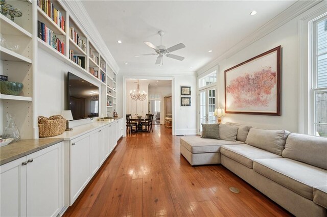 1128 Fourth St, New Orleans, LA 70130 - living room with ornamental molding, recessed lighting, ceiling fan, light wood-type flooring, and a chandelier