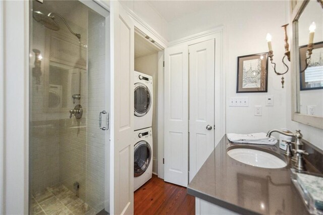 1128 Fourth St, New Orleans, LA 70130 - full bath with stacked washer / dryer, a stall shower, double vanity, and wood finished floors