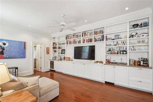 1128 Fourth St, New Orleans, LA 70130 - living room featuring wood finished floors, wine cooler, ornamental molding, ceiling fan, and bar