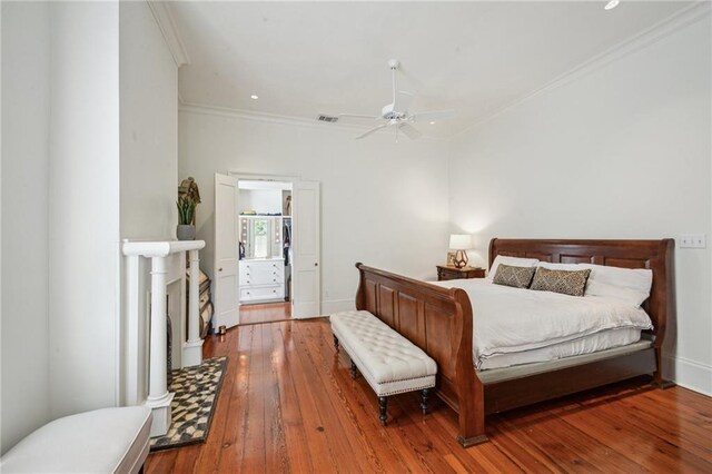 1128 Fourth St, New Orleans, LA 70130 - bedroom with crown molding, wood-type flooring, and a ceiling fan