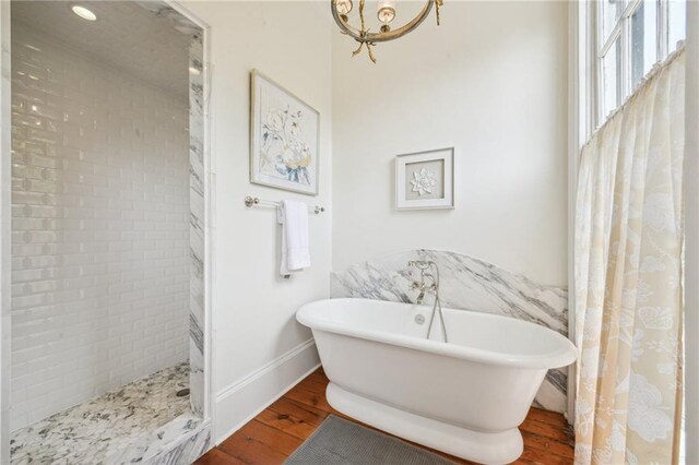 1128 Fourth St, New Orleans, LA 70130 - full bath with wood finished floors, a freestanding tub, and a tile shower