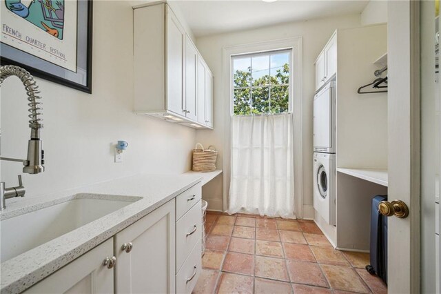 1128 Fourth St, New Orleans, LA 70130 - laundry area featuring stacked washing machine and dryer and cabinet space
