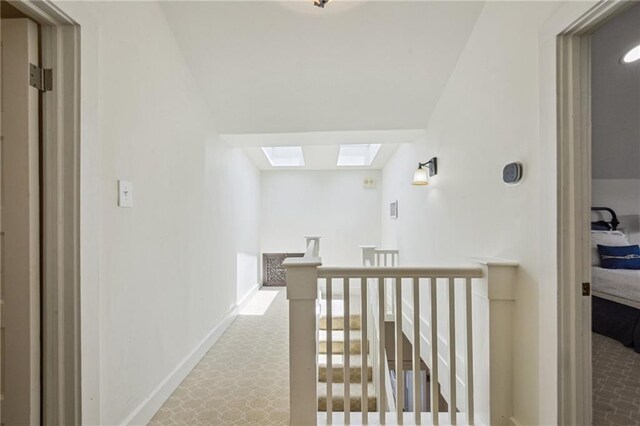 1128 Fourth St, New Orleans, LA 70130 - corridor featuring an upstairs landing, a skylight, and carpet flooring