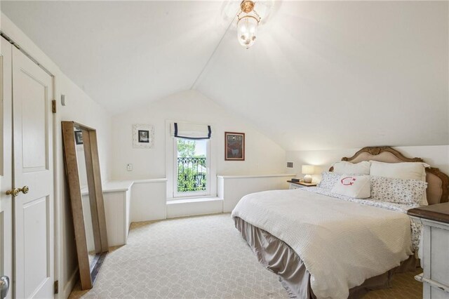 1128 Fourth St, New Orleans, LA 70130 - bedroom featuring vaulted ceiling and light carpet