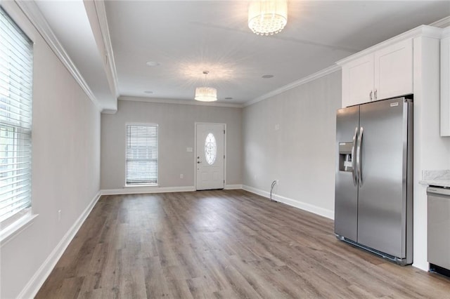 1704-1706 S Dupre St, New Orleans, LA 70125 - entrance foyer with crown molding, light wood finished floors, and a chandelier