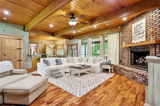 65045 Easy St, Pearl River, LA 70452 - living room featuring wood finished floors, a wood ceiling with exposed beams, ceiling fan, a brick fireplace, and recessed lighting