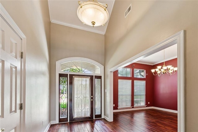 142 Colony Rd, Belle Chasse, LA 70037 - entryway with a chandelier, hardwood / wood-style floors, a towering ceiling, and crown molding