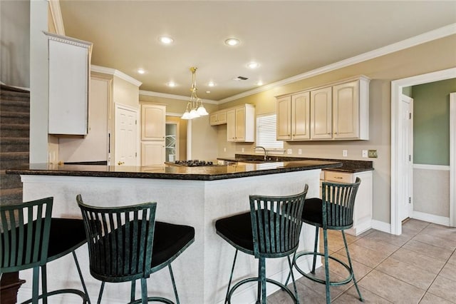 142 Colony Rd, Belle Chasse, LA 70037 - kitchen with a peninsula, ornamental molding, light tile patterned floors, recessed lighting, and a breakfast bar