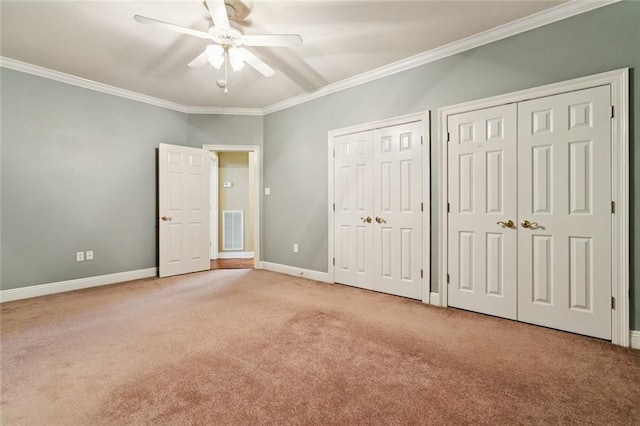 142 Colony Rd, Belle Chasse, LA 70037 - unfurnished bedroom with multiple closets, carpet flooring, crown molding, and ceiling fan