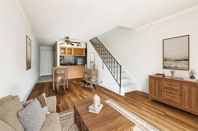 3805 Houma Blvd Unit B221, Metairie, LA 70006 - living room featuring stairs, wood finished floors, a ceiling fan, and ornamental molding