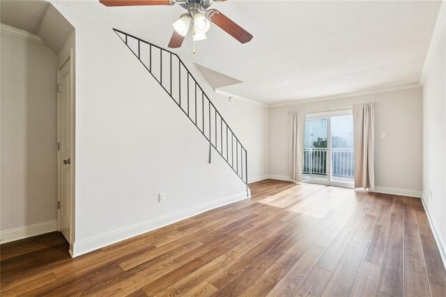 3805 Houma Blvd Unit B221, Metairie, LA 70006 - unfurnished living room with ceiling fan, stairs, wood finished floors, and crown molding