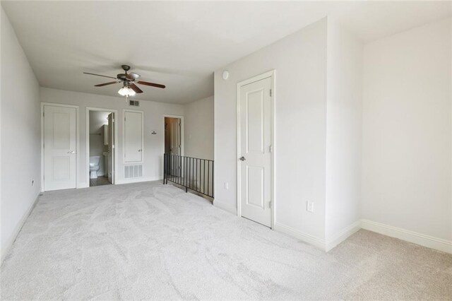 3805 Houma Blvd Unit B221, Metairie, LA 70006 - unfurnished bedroom featuring light carpet, connected bathroom, and ceiling fan