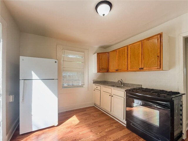 134648 S Dilton St, Metairie, LA 70003 - kitchen featuring freestanding refrigerator, black gas stove, and light wood finished floors