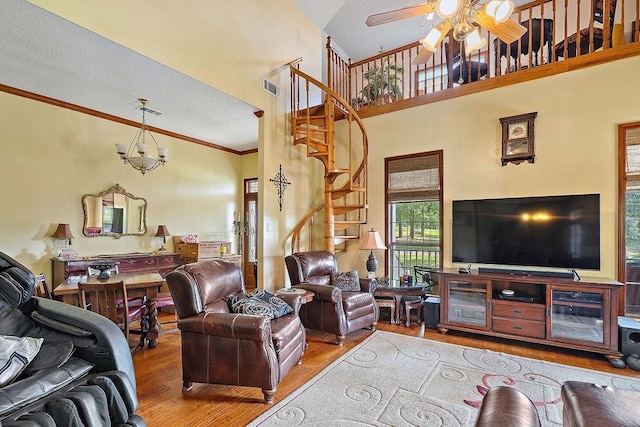 126 Gemstone Dr, Franklinton, LA 70438 - living room with wood finished floors, stairs, a high ceiling, ceiling fan, and crown molding