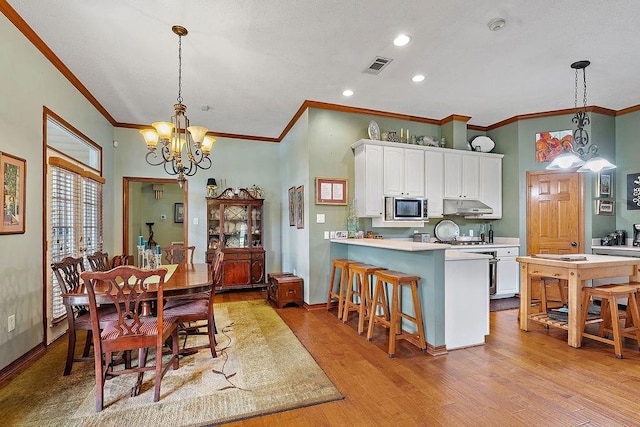 126 Gemstone Dr, Franklinton, LA 70438 - dining area with crown molding, a chandelier, light wood-type flooring, and recessed lighting