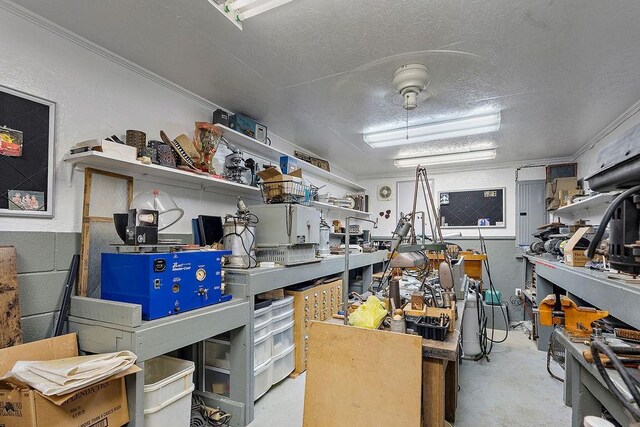 126 Gemstone Dr, Franklinton, LA 70438 - miscellaneous room with concrete floors, a workshop area, a textured ceiling, and crown molding