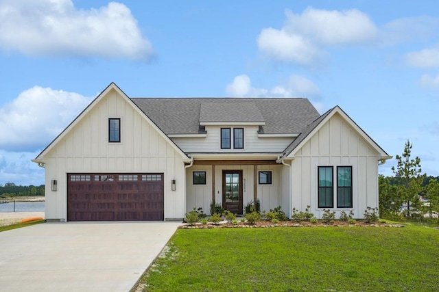 52554 Shore Dr, Franklinton, LA 70438 - modern farmhouse featuring board and batten siding, a shingled roof, a front lawn, driveway, and a garage