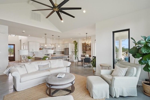 52554 Shore Dr, Franklinton, LA 70438 - living room with high vaulted ceiling, concrete floors, a ceiling fan, a chandelier, and recessed lighting