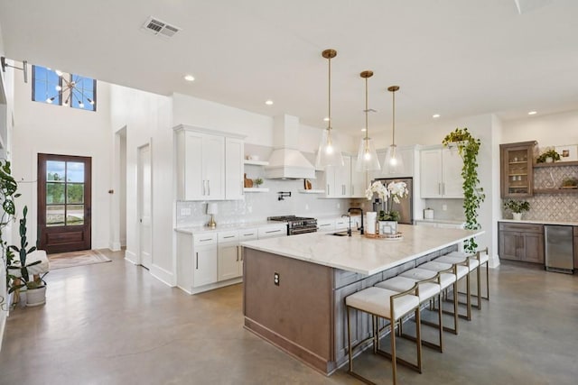 52554 Shore Dr, Franklinton, LA 70438 - kitchen featuring open shelves, custom exhaust hood, finished concrete flooring, and recessed lighting