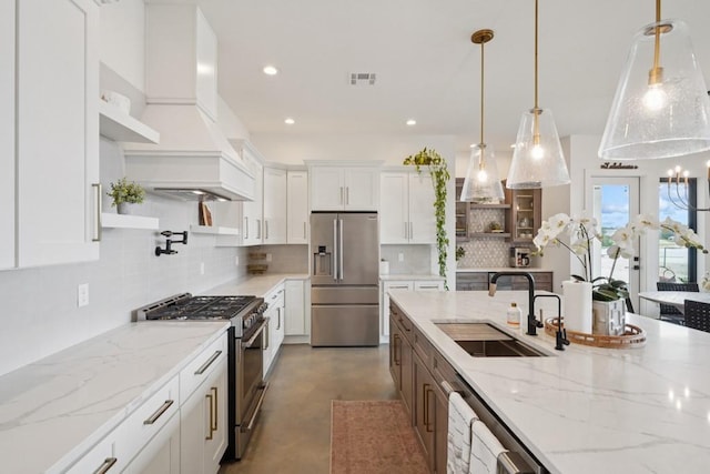 52554 Shore Dr, Franklinton, LA 70438 - kitchen with premium appliances, white cabinetry, decorative backsplash, premium range hood, and recessed lighting
